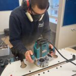 Image shows Ben, a former Touch Wood volunteer using a power tool