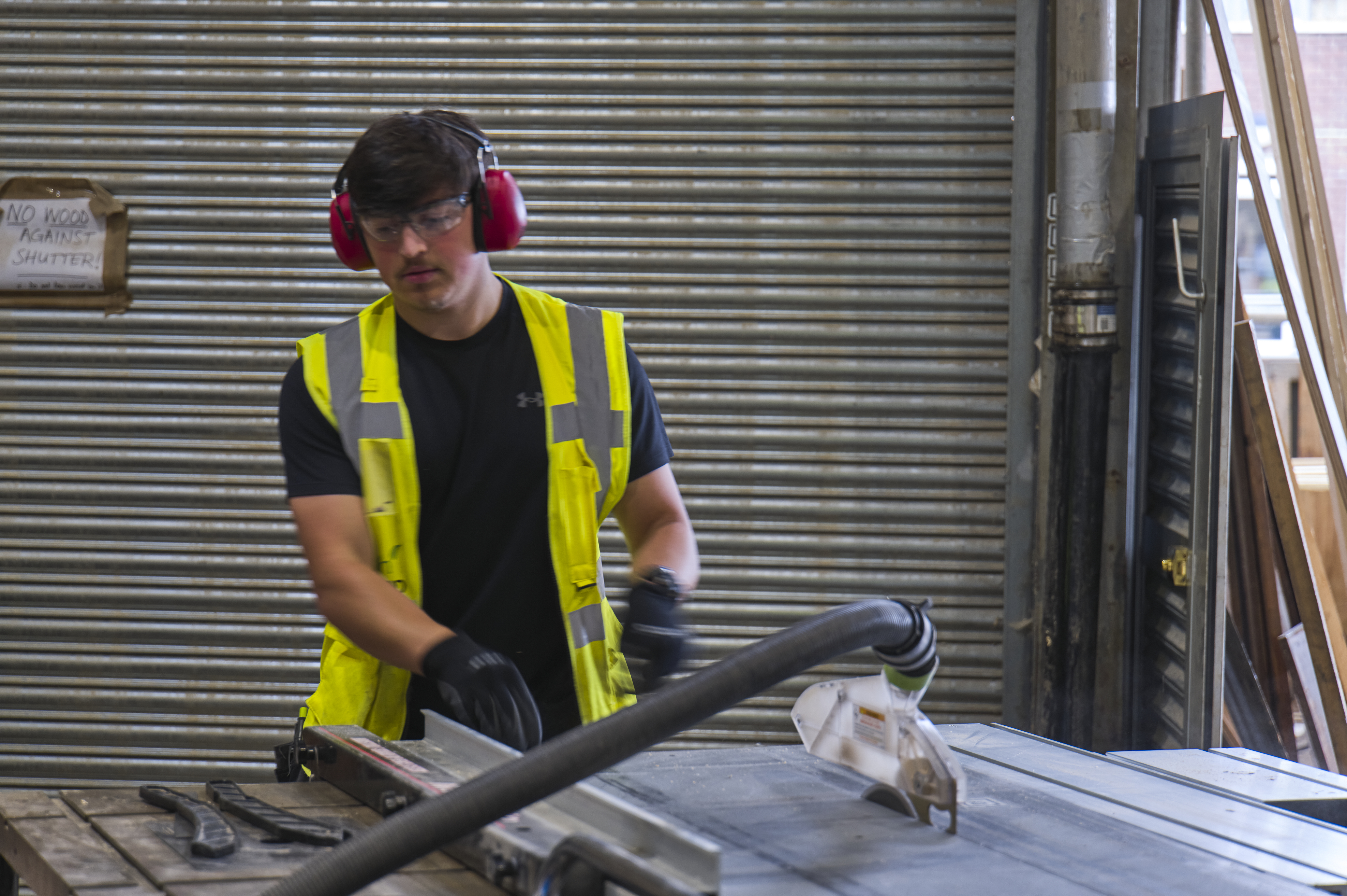 Image shows Ben, a former Touch Wood volunteer during his time with us working with a power tool