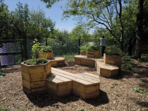 Image shows the reclaimed benches and planters at Fairfield Hospital planted up
